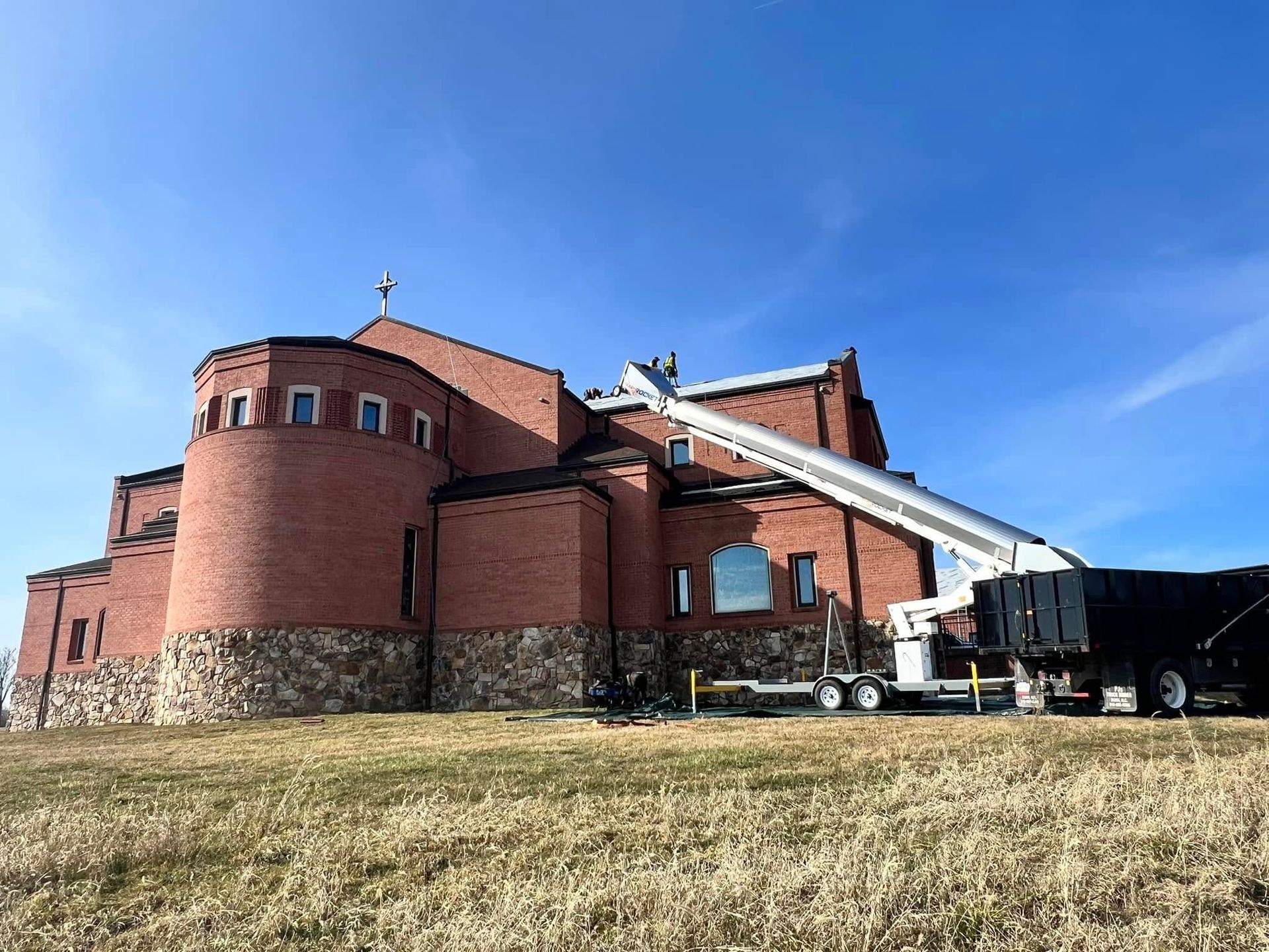 Black Stone Roofing crew and conveyor replacing a church roof in the Martinsburg WV area